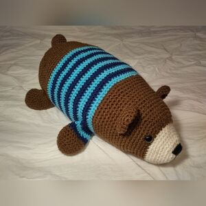 Crochet huggable lying brown bear